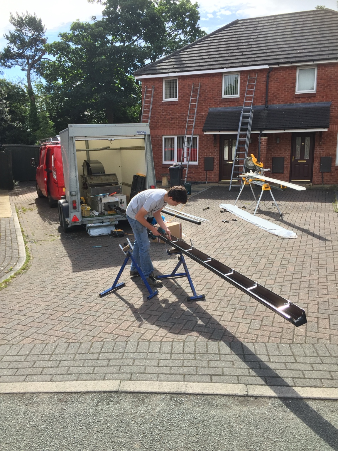 Royale Property Care preparing a continuous aluminium gutter on site