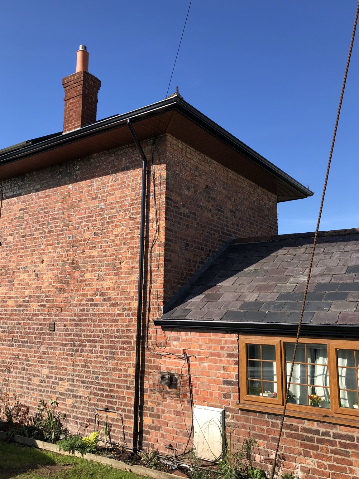 Finished light oak soffit black fascia and seamless guttering near Wem